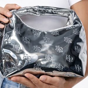 NWOT-Huda Beauty Silver Metallic Cosmetics Bag Logo